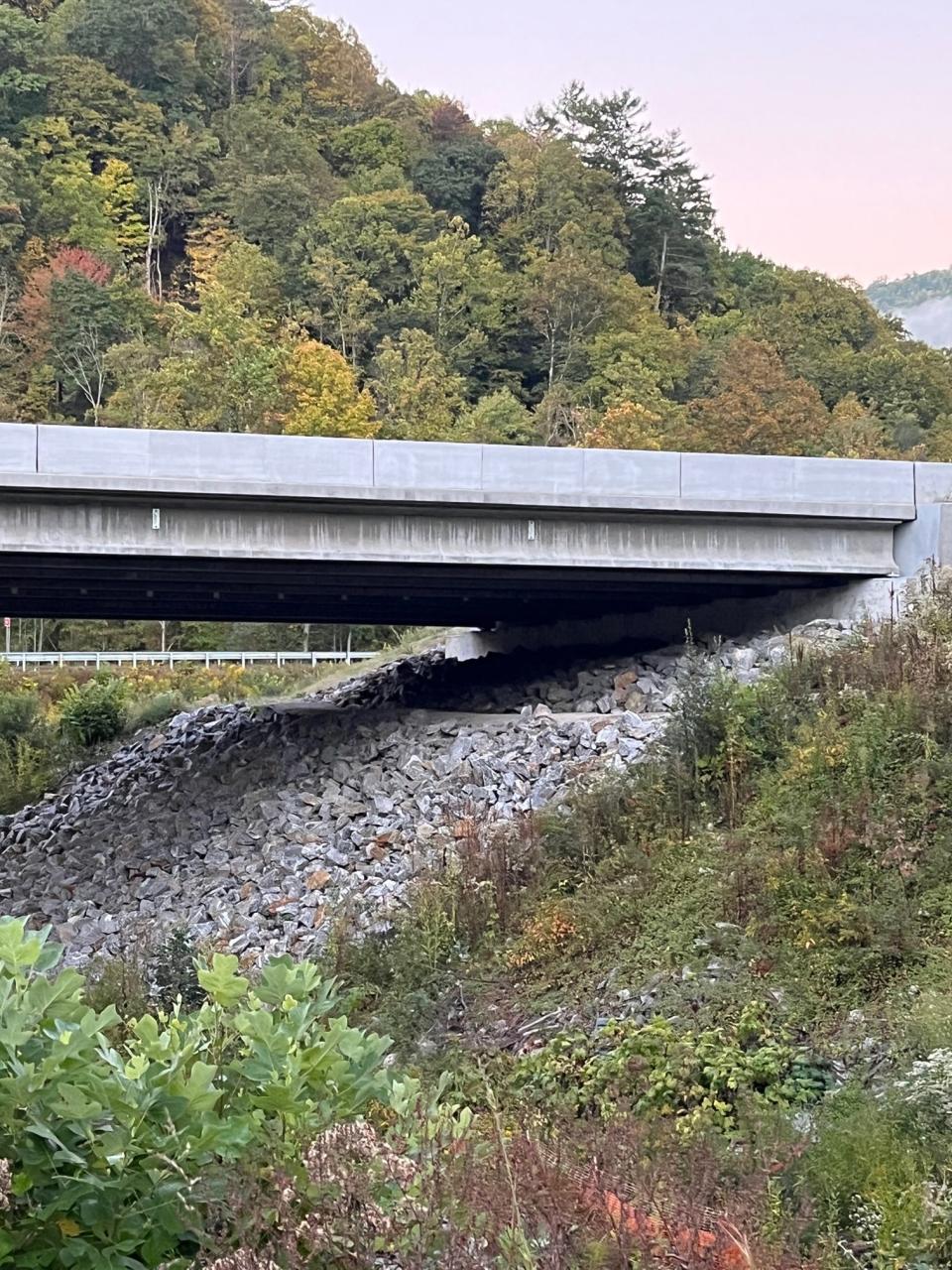 The N.C. Department of Transportation’s new bridge design includes graded benches on each side of Cold Springs Creek at Harmon Den, allowing passage for wildlife through the granite rip-rap. This is a better design for animals with hooves. In the Pigeon River Gorge, white-tailed deer and elk would otherwise struggle to walk on the rocky slope or choose to cross at the dangerous roadway.