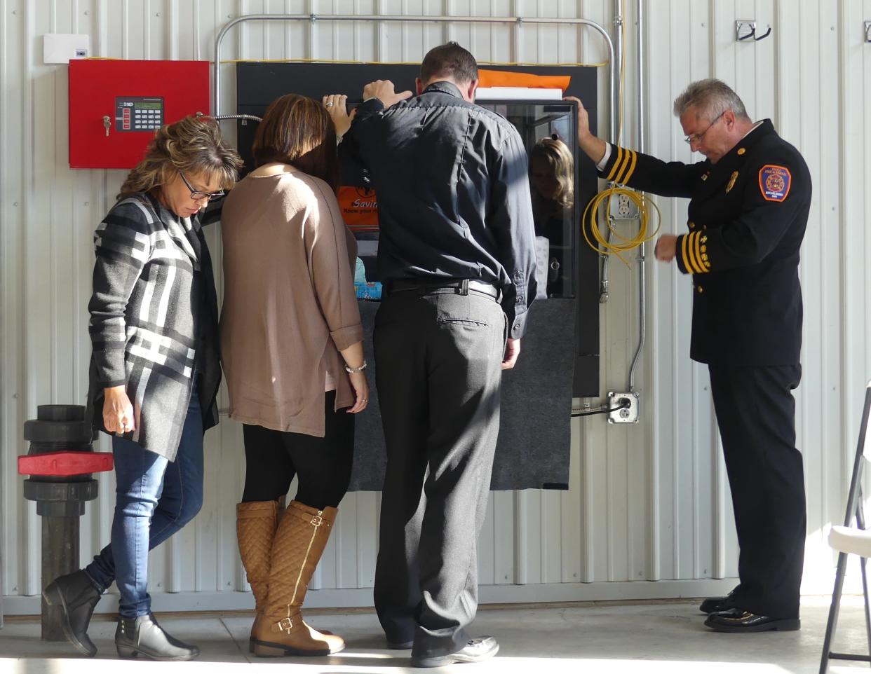 The Safe Haven Baby Box at Paoli Fire Station became available to use after a dedication ceremony that closed with a blessing of the box and any who many need to use it. Pictured are, from left to right, Safe Haven Baby Boxes founder Monica Kelsey, Tessa and Keegan Higgs and Paoli Fire Chief Mark Jones.