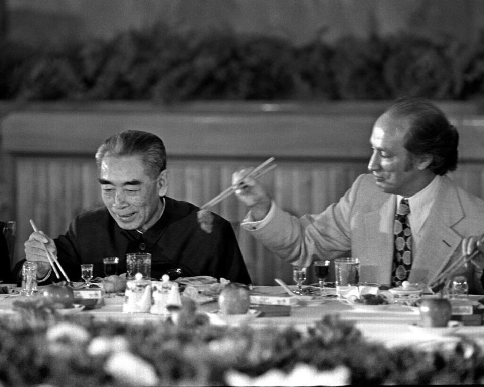 Former Chinese premier Zhou Enlai gets served some food by former prime minister Pierre Trudeau during a banquet held at the Great Hall of the People in Beijing, China, on Oct. 12, 1973. THE CANADIAN PRESS/PETER BREGG