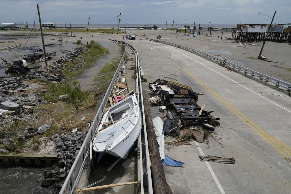 Debris and a boat are scattered over a roadway in the aftermath of Hurricane Ida in Grand Isle, La., Tuesday, Aug. 31, 2021. (AP Photo/Gerald Herbert)