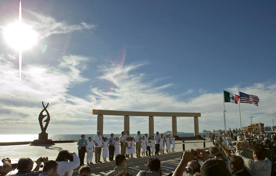 FILE - In this Sept. 27, 2007, file photo, governors representing states along the U.S.-Mexico border pose for an official portrait in Governor's Plaza as part of their Mexico-U.S. Border Conference in Puerto Penasco, Mexico. An unusual string of violence south of Arizona's border with Mexico has sparked travel warnings by American authorities and is forcing U.S. citizens who don't plan to stop crossing into Mexico to at least consider how to travel more safely. (AP Photo/Guillermo Arias, File)