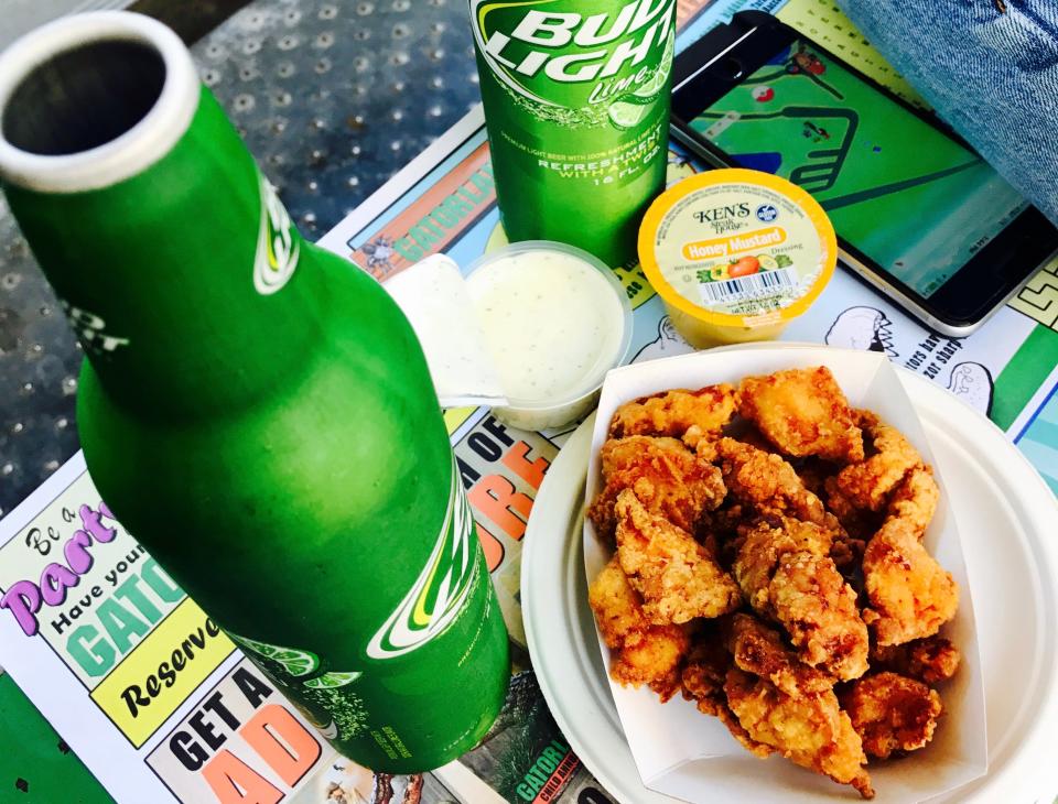 Fried alligator next to beer and honey mustard dip on tray at gatorland