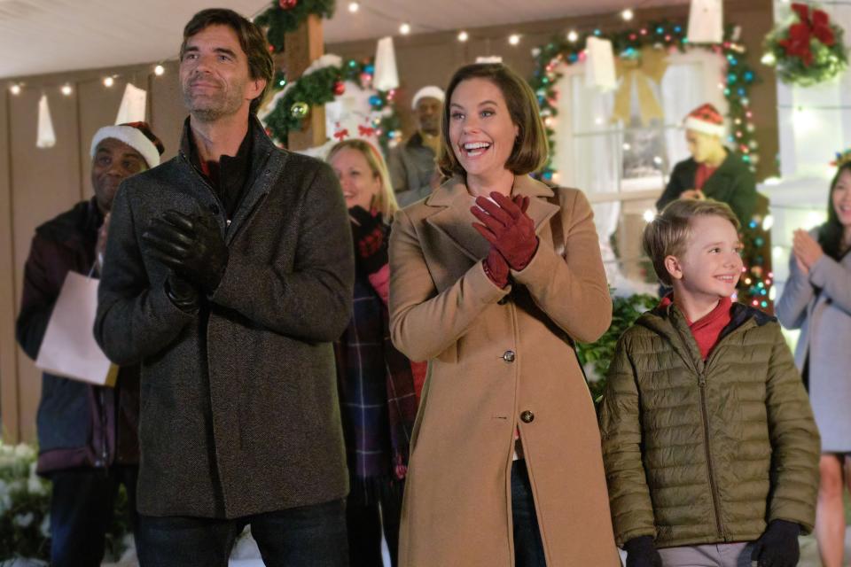 Lucas Bryant, left, and Ashley Williams, center, star in the Hallmark Movies & Mysteries holiday film “Five More Minutes: Moments Like This,” loosely inspired by a Scotty McCreery song.