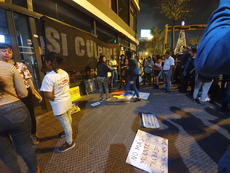 Protesters stand outside of a closed McDonald's restaurant, in Miraflores near Lima