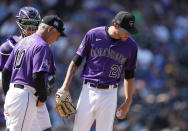 Colorado Rockies manager Bud Black, front left, chats with starting pitcher Kyle Freeland after he was arguing with the home plate umpire as catcher Dom Nunez, back left, looks on in the third inning of a baseball game against the Los Angeles Dodgers, Thursday, Sept. 23, 2021, in Denver. (AP Photo/David Zalubowski)