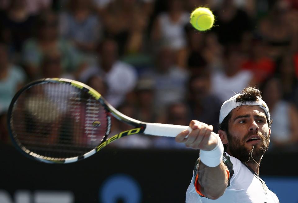 Simone Bolelli of Italy hits a return to Roger Federer of Switzerland during their men's singles second round match at the Australian Open 2015 tennis tournament in Melbourne January 21, 2015. REUTERS/Thomas Peter (AUSTRALIA - Tags: SPORT TENNIS)