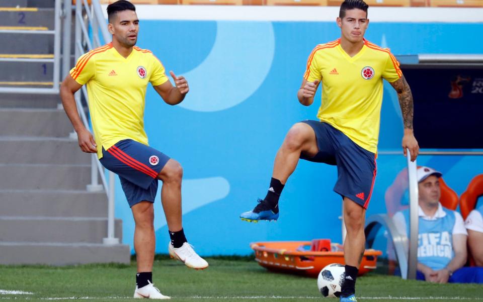 Radamel Falcao (left) and James Rodriguez warm up on the eve of Colombia's opening game of the World Cup, the Group H meeting with Japan at the Mordovia Arena in Saransk - AP