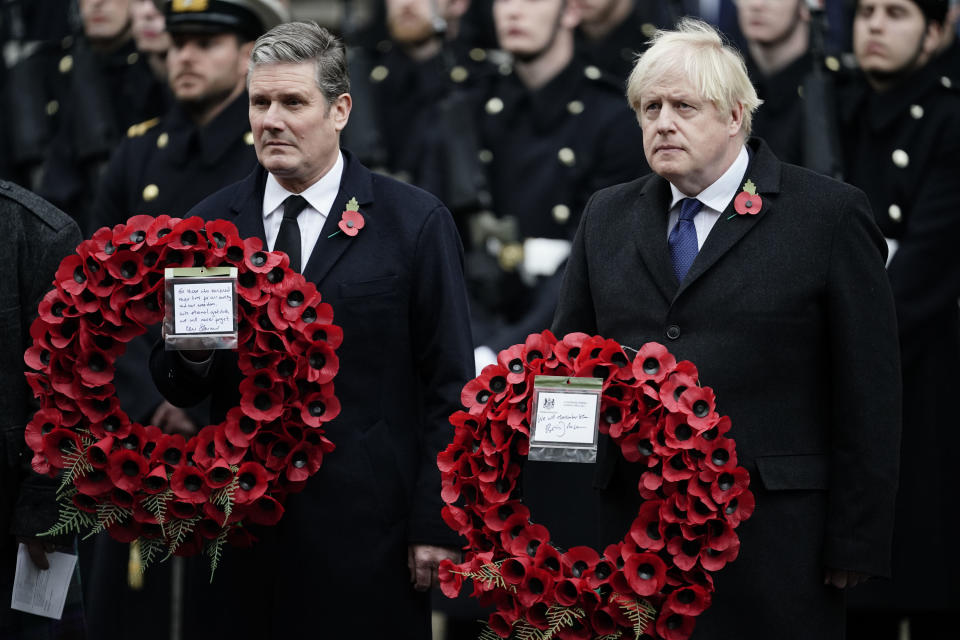 FILE - Labour Party leader Keir Starmer, left, and Prime Minister Boris Johnson lay wreaths during the Remembrance Sunday service at the Cenotaph, in Whitehall, London, Sunday Nov. 14, 2021. (Aaron Chown/Pool via AP, File)