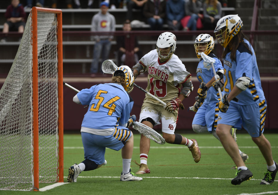 DENVER, CO - May 07: Denver Pioneers Brendan Bomberry #19 goes after a loose ball in front of Marquette Golden Eagles goalie Cole Blazer #54 in the third quarter during the Big East Championship game at Peter Barton Stadium May 07, 2016. (Photo by Andy Cross/The Denver Post via Getty Images)