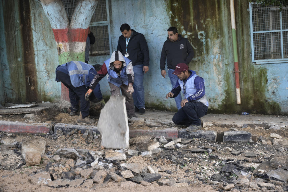 Workers remove rubble at the site where three Palestinians were killed by Israeli fire in Faraa refugee camp near the West Bank town of Tubas, Tuesday, Feb. 27, 2024. Israeli troops shot and killed three Palestinian men including Mohamed Daraghmeh, a co-founder of the local branch of the Islamic Jihad militant group, in the northern town of Tubas, early Tuesday, Palestinian health authorities said. Thee was no immediate comment from the Israeli military. (AP Photo/Majdi Mohammed)