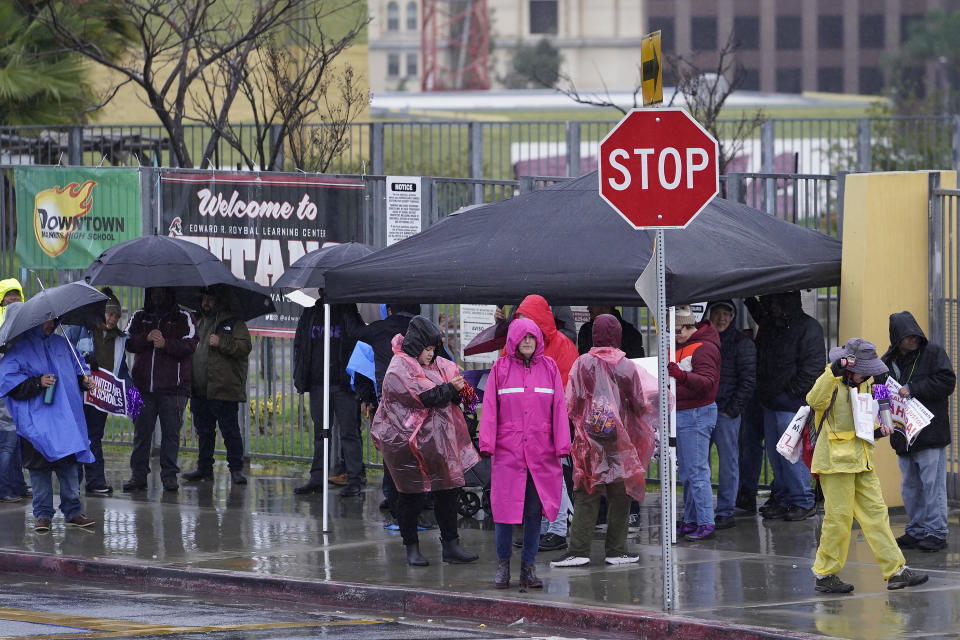 Los Angeles Unified School District, LAUSD teachers and Service Employees International Union 99 (SEIU) members strike during heavy rain outside the Edward R. Roybal Learning Center in Los Angeles Tuesday, March 21, 2023. Tens of thousands of workers in the Los Angeles Unified School District walked off the job Tuesday over stalled contract talks, and they were joined by teachers in a three-day strike that shut down the nation’s second-largest school system. (AP Photo/Damian Dovarganes)