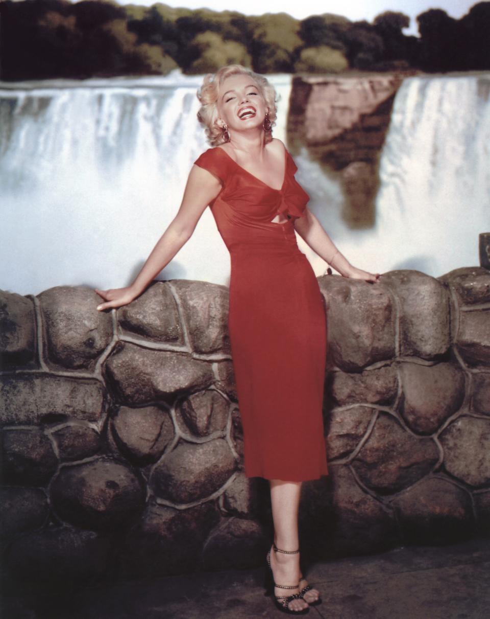 Marilyn Monroe on the set of "Niagara" in a red version of her iconic pink dress.