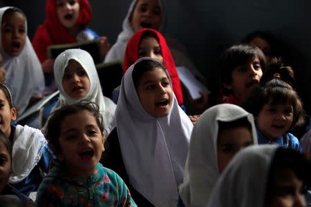 Girls recite their lesson while attending their daily class at a government school in Peshawar October 29, 2014. REUTERS/Fayaz Aziz