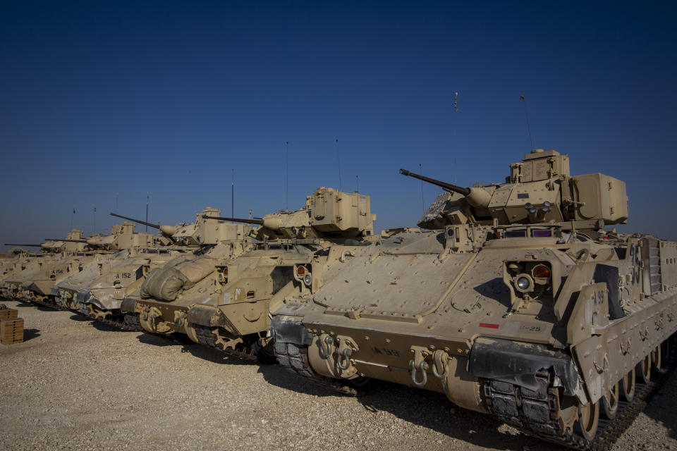 Bradley fighting vehicles are parked at a US military base at an undisclosed location in Northeastern Syria, Monday, Nov. 11, 2019. The deployment of the mechanized force comes after US troops withdrew from northeastern Syria, making way for a Turkish offensive that began last month. (AP Photo/Darko Bandic)