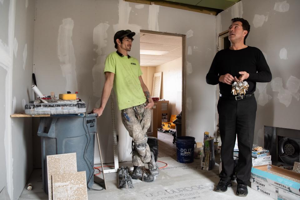 Zach Michener, left, a contractor, and Tom Skiffington, owner of the Bush House Hotel, in Quakertown, stand inside a third floor unit undergoing renovations, Monday, April 4, 2022.