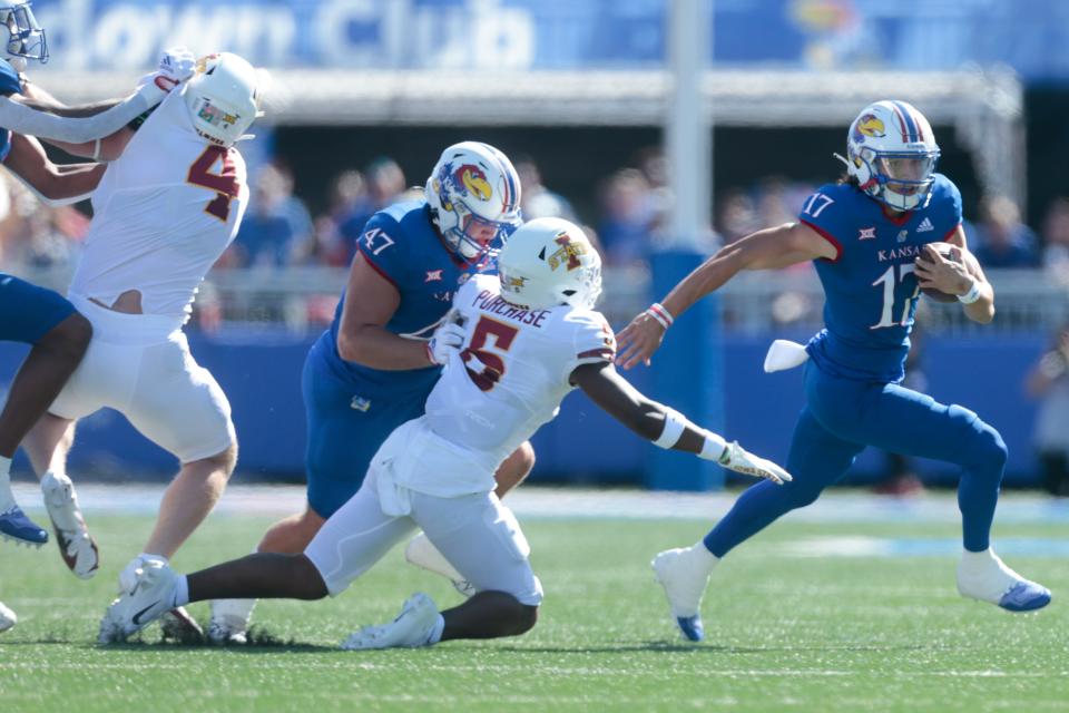 Kansas redshirt senior quarterback Jason Bean (17) avoids Iowa State defenders to get a first down in the first quarter of Saturday's game inside David Booth Kansas Memorial Stadium.