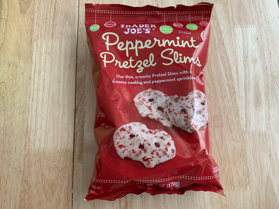 red bag of trader joes peppermint pretzel slims on wood table