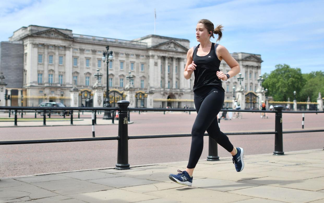 A woman jogs past Buckingham Palace last week -  JUSTIN TALLIS/ AFP