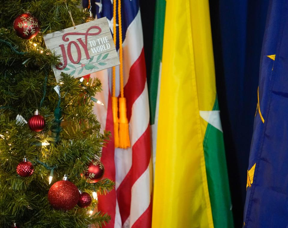 A Christmas tree and flags representing the United States, Myanmar, and the state of Indiana are on display Wednesday, Dec. 20, 2023, at Burmese American Community Institute in Indianapolis.