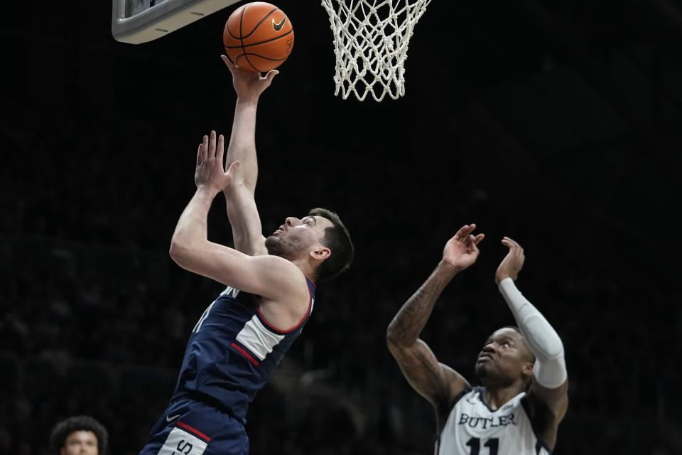 UConn's Alex Karaban, front left, shoots against Butler's Jahmyl Telfort, right, during the second half of an NCAA college basketball game, Friday, Jan. 5, 2024, in Indianapolis. (AP Photo/Darron Cummings)