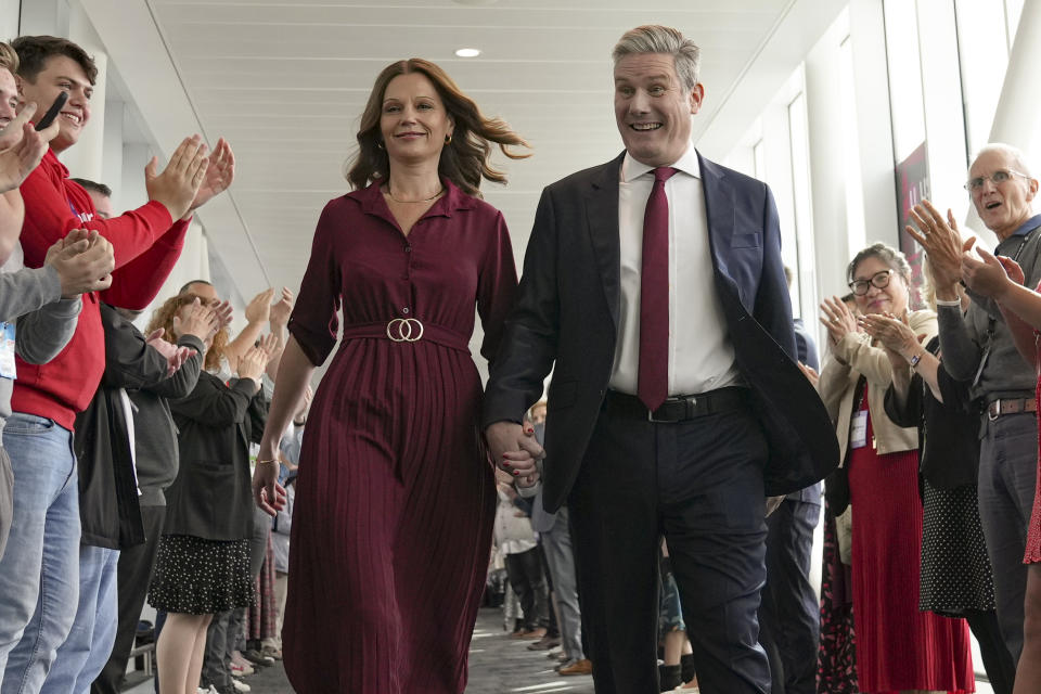 FILE - Keir Starmer, the leader of Britain's Labour Party walks with his wife Victoria as supporters applaud before his speech at the party's annual conference in Liverpool, England, Tuesday, Sept. 27, 2022. (AP Photo/Jon Super, File)