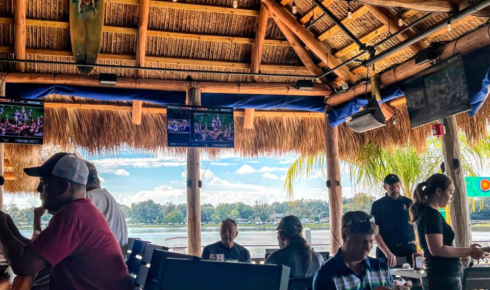 Ski Beach Bar & Grill customers drink, dine and watch sports in a tiki bar off Lake Harris.