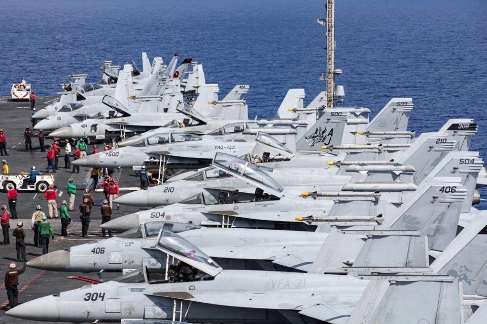A photo of a row of fighter planes aboard the USS Gerald R. Ford.