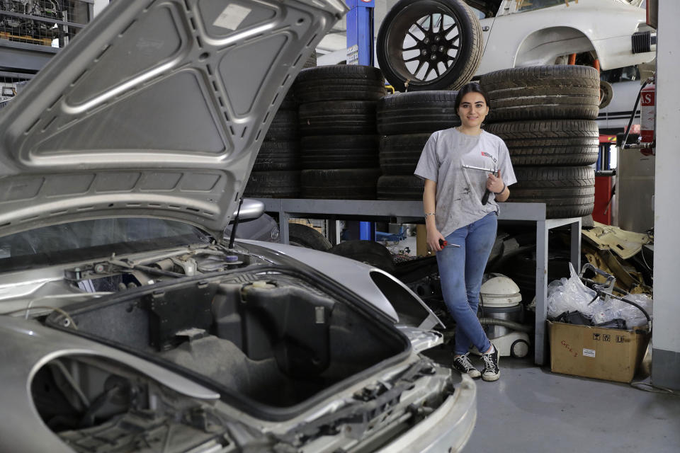 <p>Lebanese mechanic Rana el-Hayek, 22, poses in a car repair garage where she works in Qannabat Brummana, northeast of Beirut, on March 3, 2018. (Photo: Joseph Eid/AFP/Getty Images) </p>