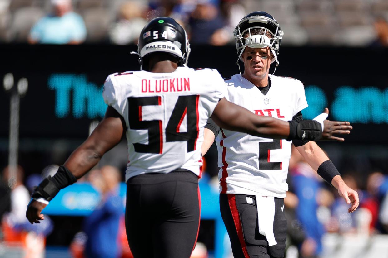 Matt Ryan (2) and Foyesade Oluokun (54) of the Atlanta Falcons on the field during warm ups before a game against the New York Giants at MetLife Stadium on Sept. 26, 2021 in East Rutherford, New Jersey.