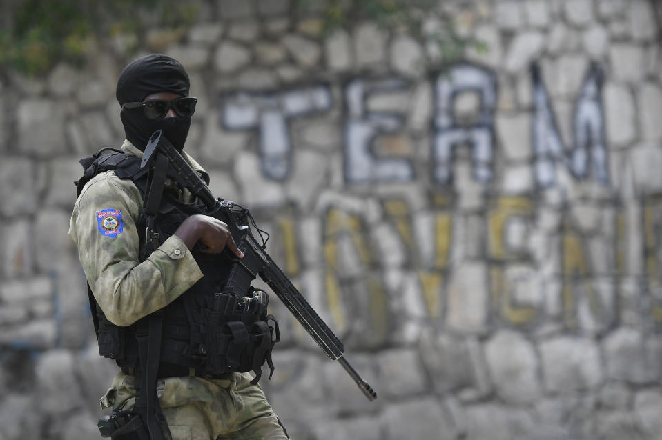 A Haitian police officer stands outside President Jovenel Moise´s residence while FBI agents inspect the inside of the place, in Port-au-Prince, Haiti, Thursday, July 15, 2021. President Moise was assassinated in the residence on July 7. (AP Photo/Matias Delacroix)