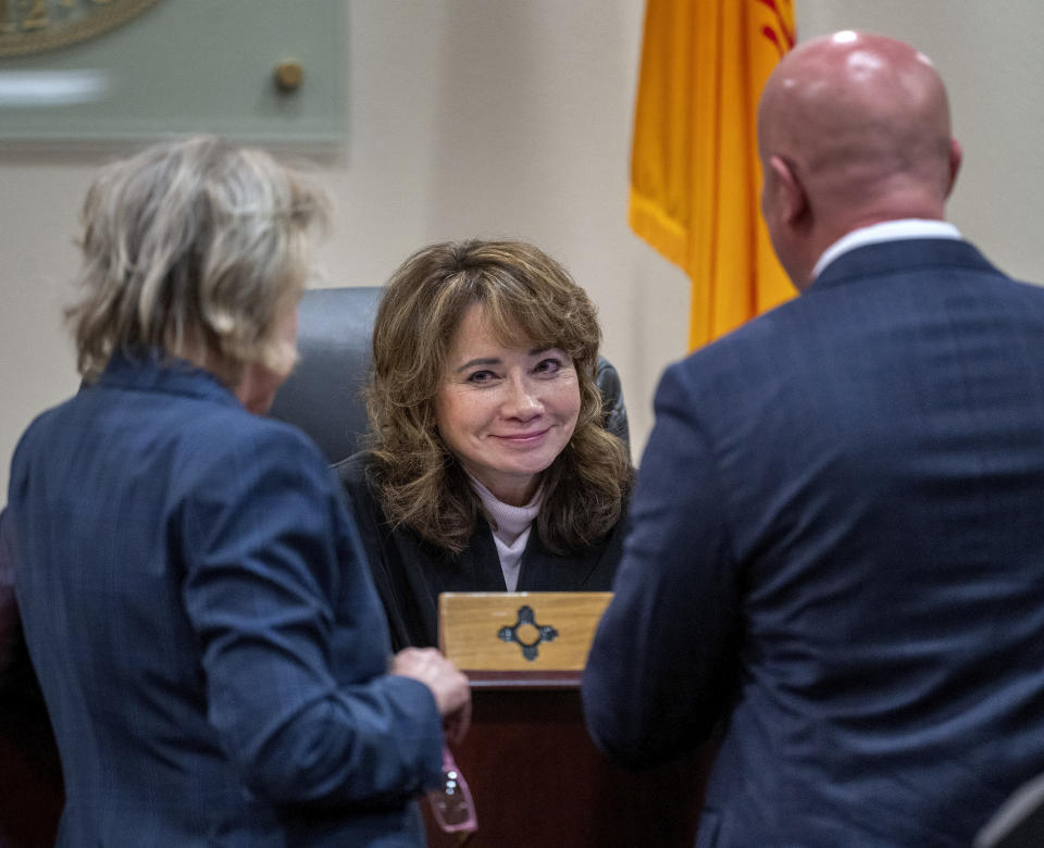 CORRECTS SOURCE TO ALBUQUERQUE JOURNAL INSTEAD OF SANTA FE NEW MEXICAN - Judge Mary Marlowe Sommer, center, talks with prosecutor Kari Morrissey, left, and defense attorney Jason Bowles during the first day of testimony in the case against Hannah Gutierrez-Reed, in First District Court, in Santa Fe, N.M., Thursday, Feb. 22, 2024. Gutierrez-Reed, who was working as the armorer on the movie "Rust" when a revolver actor Alec Baldwin was holding fired killing cinematographer Halyna Hutchins and wounded the film’s director, Joel Souza, is charged with involuntary manslaughter and tampering with evidence. (Eddie Moore/The Albuquerque Journal via AP, Pool)