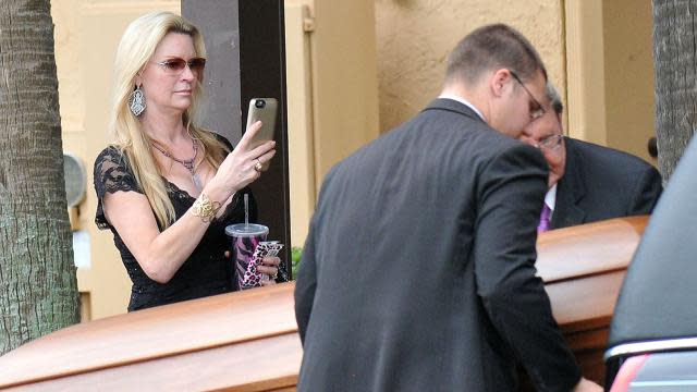 David and Jackie Siegel, subjects of the 2012 documentary <em>Queen of Versailles</em>, laid their 18-year-old daughter Victoria to rest on Tuesday after she was found unresponsive in the family's Florida home. Outside the service, Jackie Siegel was spotted holding a cellphone in what appeared to be images of her snapping photos of her daughter's casket as it was loaded into a hearse. Victoria's body was then taken to Woodlawn Cemetery in Gotha, Fla. where she was buried during a private service. Getty Images Victoria’s official obituary described her as a "down to earth hippie girl" and "an earthly angel with a sensitive nature and caring soul." The obit also detailed the teen’s long bucket list, which included skydiving, professional poker player, deep sea fishing, opening a campsite, and opening a sushi restaurant at the Cocoa Beach Pier. <strong> PHOTOS: Stars We've Lost </strong> The Siegel family addressed speculation and rumors surrounding Victoria’s death on Monday, in a statement saying, "Victoria had a history of seizures and was prescribed medication for this condition. Unfortunately she became dependent and struggled with this condition. She voluntarily underwent rehabilitation and was working hard to address this problem." Getty Images <strong> NEWS: Family Addresses Circumstances Surrounding Victoria Siegel's Death </strong> The Siegel family announced they were starting the Victoria Siegel Foundation, which "will be dedicated to helping troubled teens with addiction issues, similar to the Betty Ford Clinic." They asked that contributions to the foundation be made in lieu of flowers. 