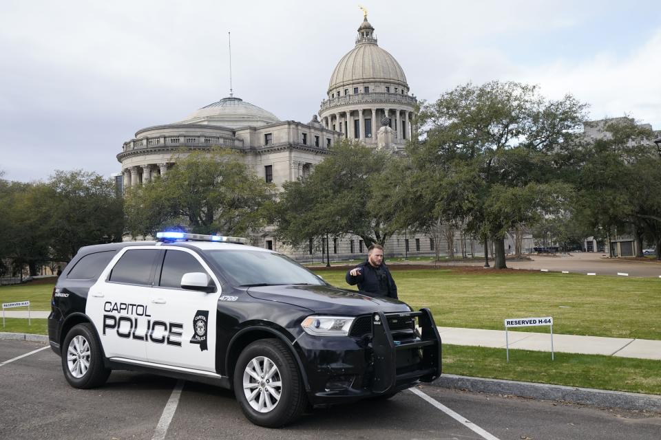 A Capitol Police officer warns off passersby as they respond to a bomb threat at the Mississippi state Capitol in Jackson, Miss., on Jan. 3, 2024.