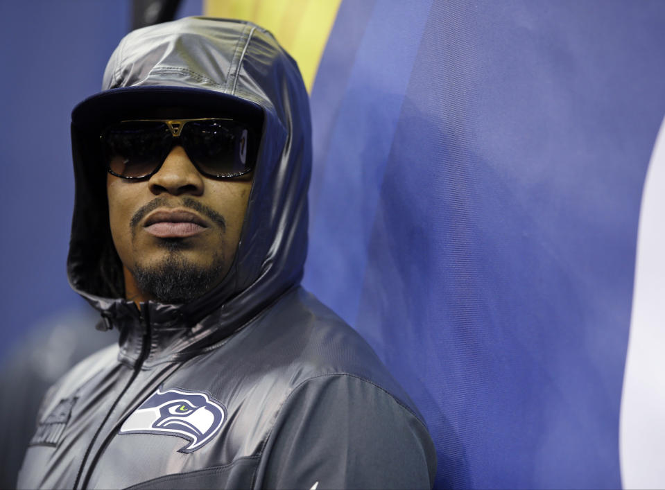 FILE - In this Jan. 28, 2014, file photo, Seattle Seahawks' Marshawn Lynch stands against a wall during media day for the NFL Super Bowl XLVIII football game in Newark, N.J. The history of Super Bowl Media Day has played a key role in making the Super Bowl the most-watched NFL TV program. (AP Photo/Matt Slocum, File)