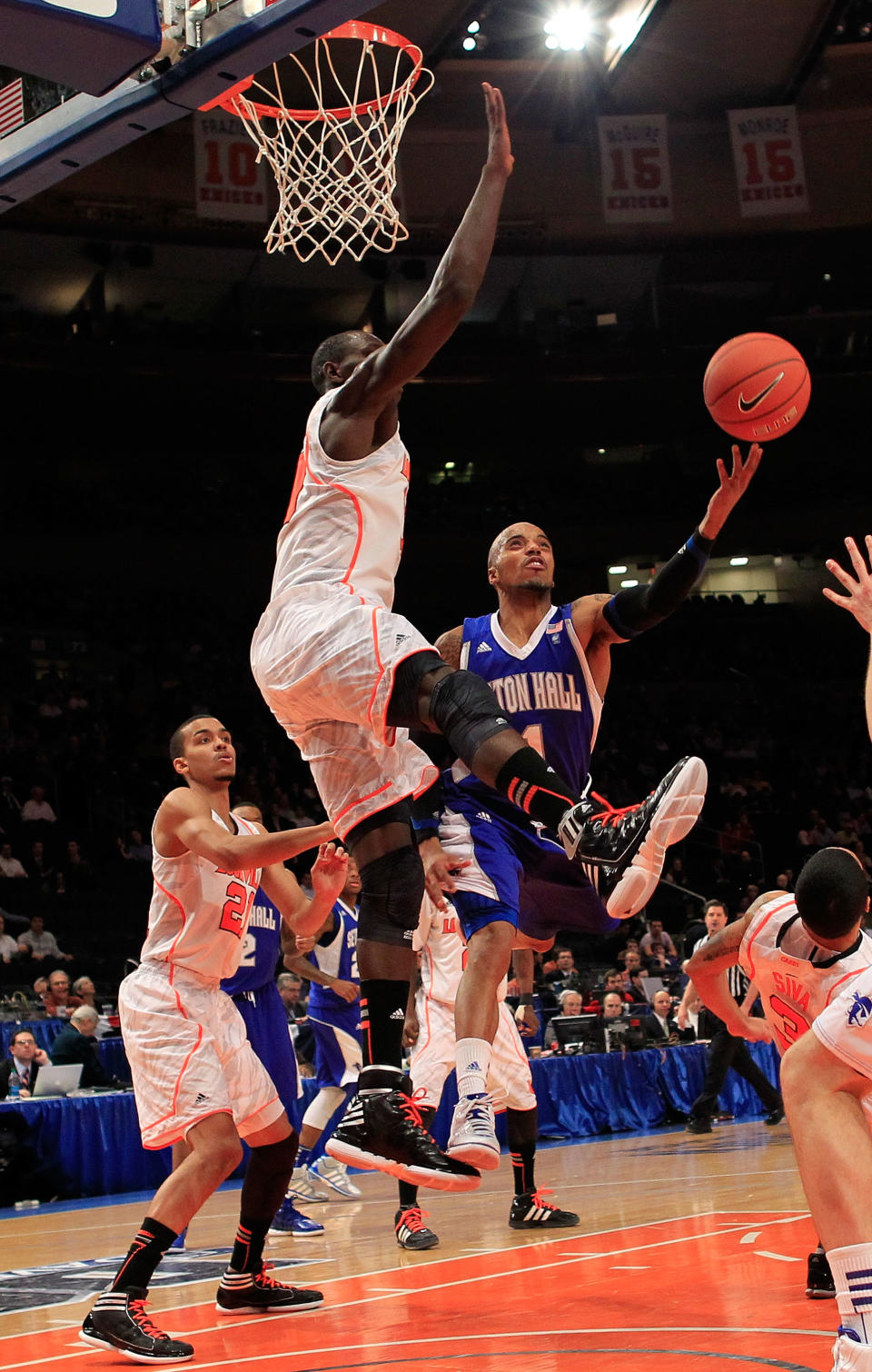 NEW YORK, NY - MARCH 07: Jordan Theodore #1 of the Seton Hall Pirates goes to the hoop against Gorgui Dieng #10 of the Louisville Cardinals during their second round game of the Big East Men's Basketball Tournament at Madison Square Garden on March 7, 2012 in New York City. (Photo by Chris Trotman/Getty Images)