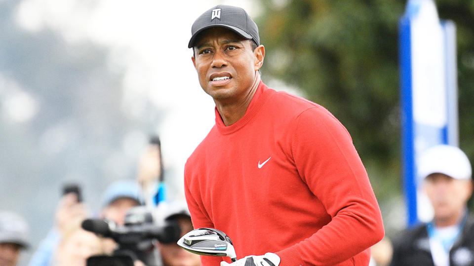 Tiger Woods watches closely as he hits a tee shot.