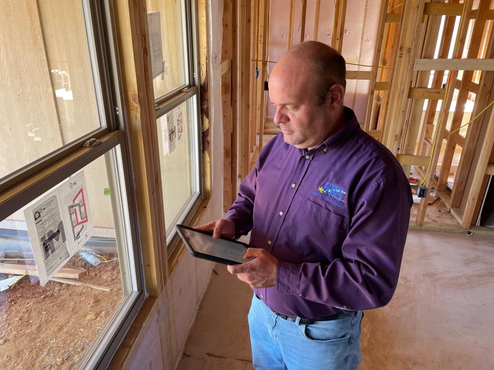 Matt Risinger, residential home inspector for Guaranteed Watt Saver, conducts an interim energy inspection Friday at a home in Valencia addition in northwest Oklahoma City.