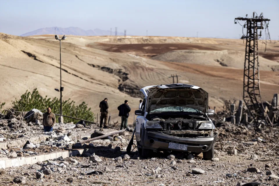 FILE -- People inspect a site damaged by Turkish airstrikes that hit an electricity station in the village of Taql Baql, in Hasakeh province, Syria, Sunday, Nov. 20, 2022. Turkish airstrikes on northern Syria over the weekend that killed and wounded a number of Syrian soldiers could pose a setback to the recent move toward a rapprochement between the two countries after 11 years of tension and hostility. (AP Photo/Baderkhan Ahmad, File)