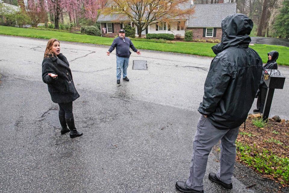 Homeowner and resident Amanda Clappsy, Westminster Civic Association President Michal Porter, and resident Matt Allen argue outside Clappsy's home on Tuesday, April 2, 2024. Clappsy, after clearing with the community’s prior board, reconfigured her driveway so she could park her RV but has been having problems with the new civic association board due to her RV.