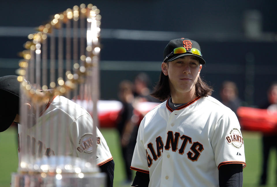 SAN FRANCISCO, CA - APRIL 08:  Tim Lincecum #55 of the San Francisco looks on as he stands next to the 2010 World Series trophy before the start of the Giants' opening day game against the St. Louis Cardinals at AT&T Park on April 8, 2011 in San Francisco, California.  (Photo by Marcio Jose Sanchez-Pool/Getty Images)