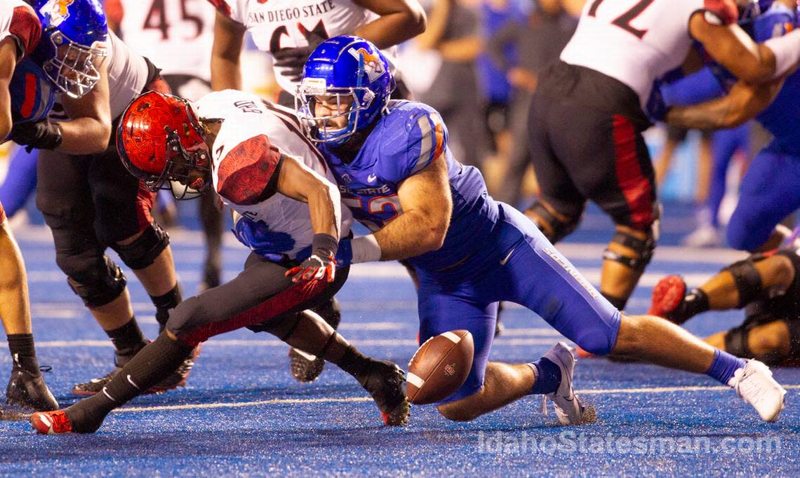 Boise State linebacker DJ Schramm forces a fumble from San Diego State running back Jordan Byrd during the second half. Boise State defeated San Diego State University 35-13 at Albertsons Stadium.