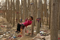 <p>A Kashmiri child reacts to the camera as she plays on a custom-made swing outside her riverside shanty home in Srinagar, Indian-controlled Kashmir, Feb 27, 2017. Kashmir is a green, saucer-shaped valley surrounded by snowy mountain ranges with many lakes dotting its highlands and plains.(AP Photo/Mukhtar Khan) </p>