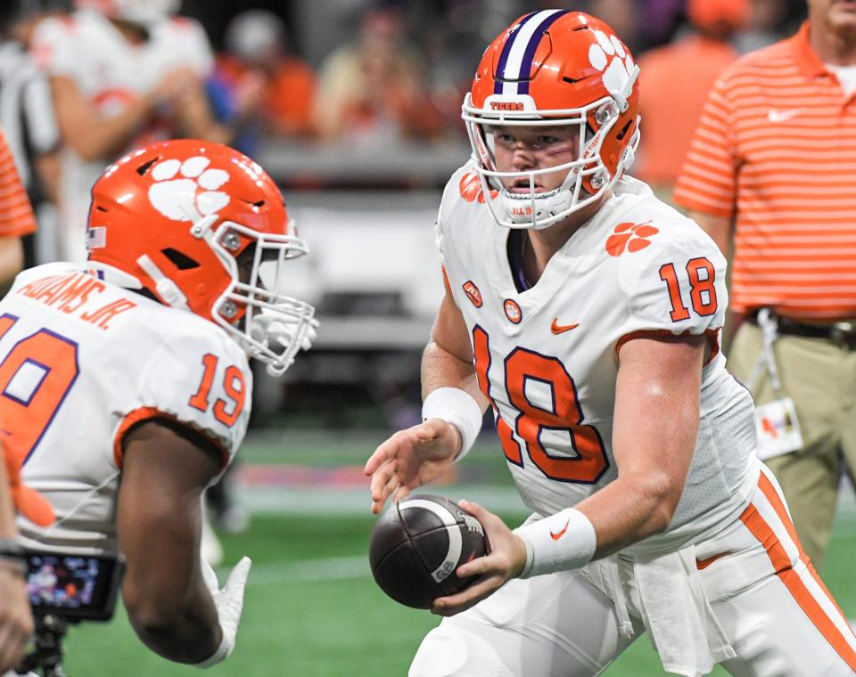 Then-Clemson quarterback Hunter Helms hands the ball off to running back Keith Adams during a 2022 game. Helms is now competing for the URI starting QB job.