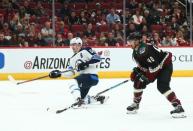 Apr 6, 2019; Glendale, AZ, USA; Winnipeg Jets center Mark Scheifele (55) takes a shot on goal against the Arizona Coyotes in the second period at Gila River Arena. Mandatory Credit: Mark J. Rebilas-USA TODAY Sports