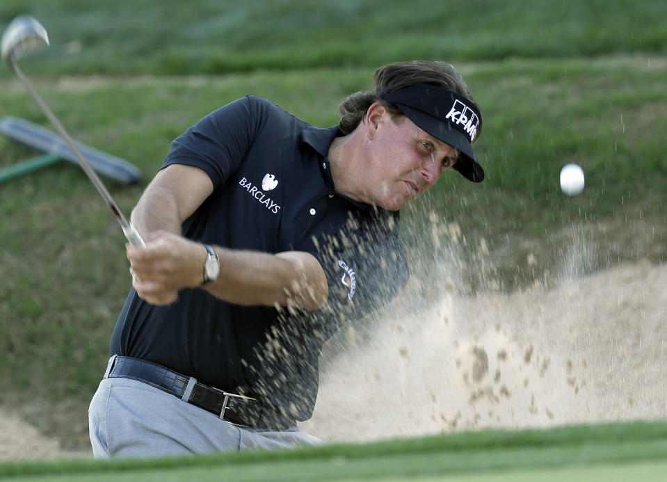 Phil Mickelson blasts from a sand trap on the 16th hole during the second round of the Texas Open golf tournament on Friday, March 28, 2014, in San Antonio. (AP Photo/Eric Gay)