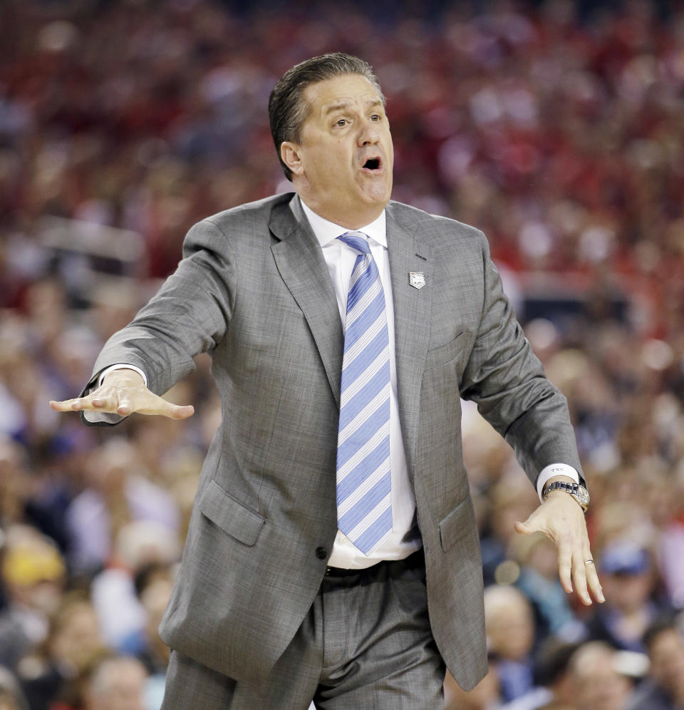 Kentucky head coach John Calipari works the sideline against Wisconsin during the first half of the NCAA Final Four tournament college basketball semifinal game Saturday, April 5, 2014, in Arlington, Texas. (AP Photo/David J. Phillip)