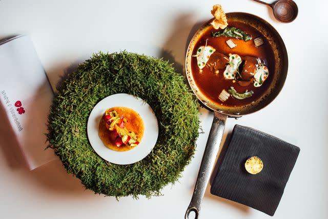 <p>James Rajotte</p> At DiverXO, a squash-blossom taco on a bed of moss sits next to rooster stew made with beans, citrus, and herbs.