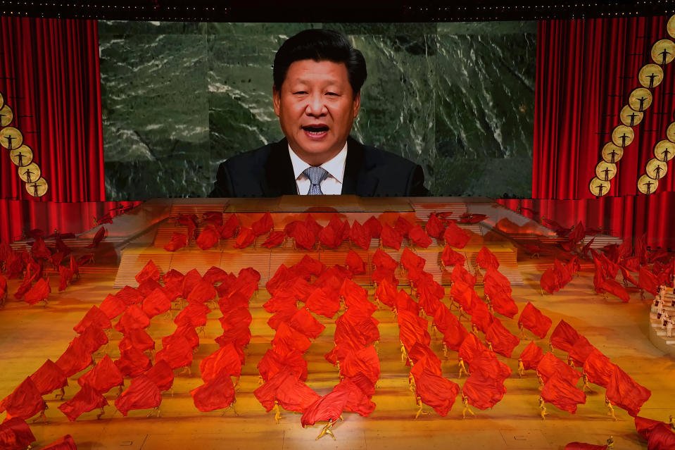 FILE - Chinese President Xi Jinping is displayed on a screen as performers dance at a gala show ahead of the 100th anniversary of the founding of the Chinese Communist Party in Beijing on June 28, 2021. When Xi Jinping came to power in 2012, it wasn't clear what kind of leader he would be. His low-key persona during a steady rise through the ranks of the Communist Party gave no hint that he would evolve into one of modern China's most dominant leaders, or that he would put the economically and militarily ascendant country on a collision course with the U.S.-led international order. (AP Photo/Ng Han Guan, File)