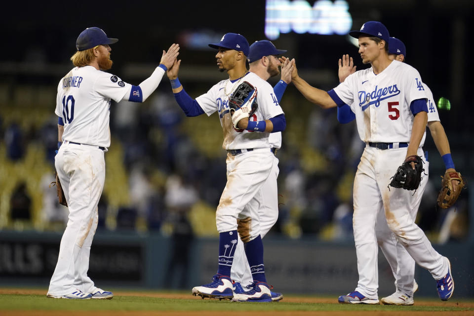 The Los Angeles Dodgers celebrate a win over the Arizona Diamondbacks during a baseball game Monday, Sept. 13, 2021, in Los Angeles. (AP Photo/Marcio Jose Sanchez)