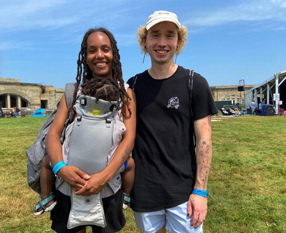 Qun White, John Robinson and baby Kingston, from Connecticut, attend the Newport Folk Festival, Monday July 26, 2021.
